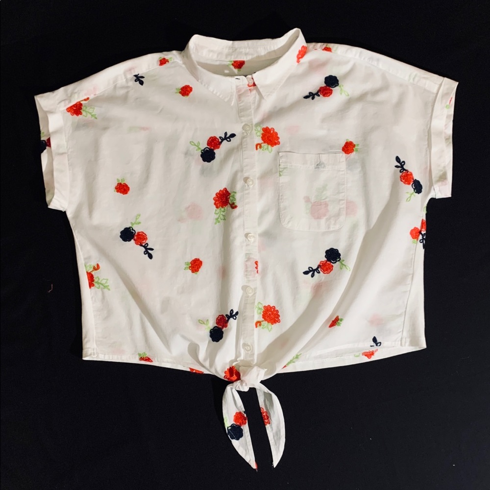 White top with red and blue accents